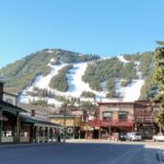 Ski slopes in Jackson Hole with panorama of vintage houses.