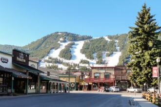 Ski slopes in Jackson Hole with panorama of vintage houses.