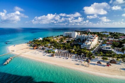 Aerial view of Isla Mujeres, Mexico with blue waters, beaches, and a resort