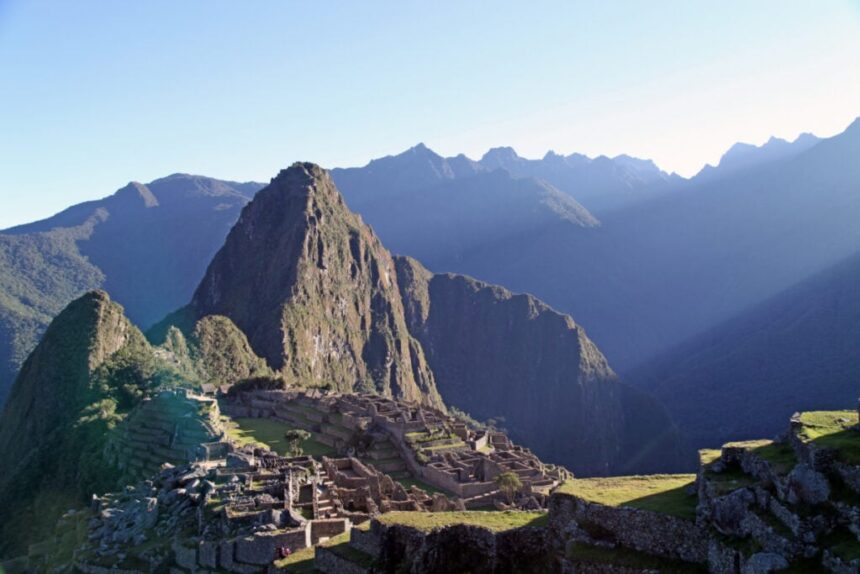 Macchu Picchu with light hitting it and mist coming off it