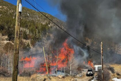 Brush fire sparks along I-70 in Colorado from house engulfed in flames
