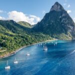 Aerial view of sailing yachts anchored in front of the Petit Piton mountain peak in Soufriere, Saint Lucia
