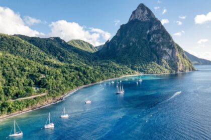 Aerial view of sailing yachts anchored in front of the Petit Piton mountain peak in Soufriere, Saint Lucia