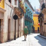 Man walking through colorful street in Guanajuato, Mexico