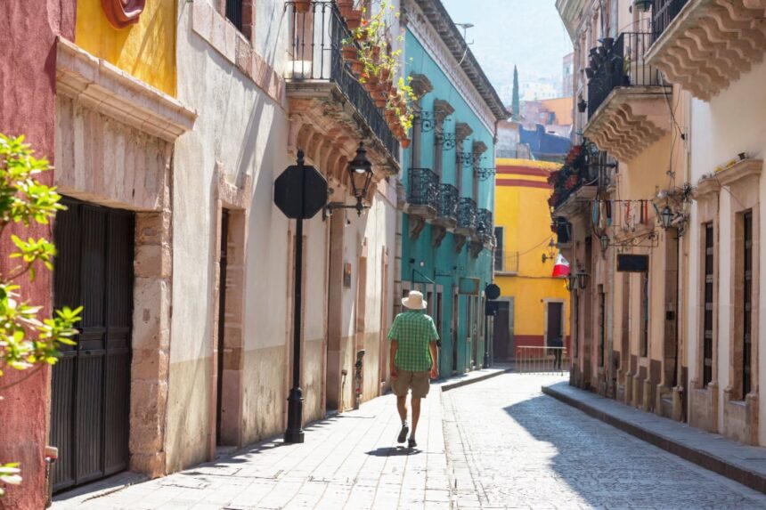 Man walking through colorful street in Guanajuato, Mexico