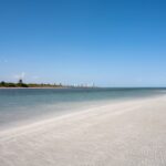 White-sand beach of Virginia Key with Miami skyline in the distance