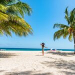 woman on beach in Barbados island. Caribbean holidays. Dover beach, travel destination. Girl walking with sun hat