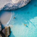 Tres Trapi Steps Triple Steps Beach, Aruba completely empty, Popular beach among locals and tourists, crystal clear ocean Aruba. Caribbean, couple man and woman in a crystal clear ocean