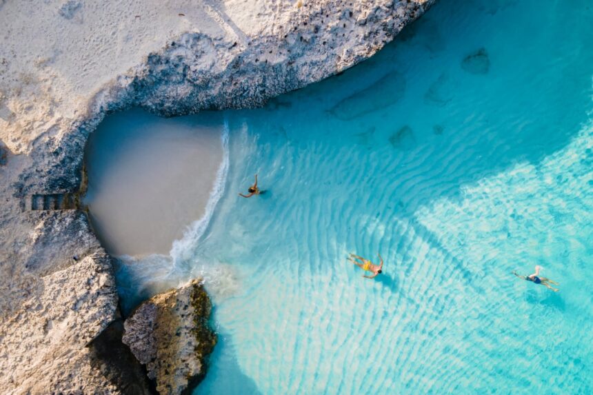 Tres Trapi Steps Triple Steps Beach, Aruba completely empty, Popular beach among locals and tourists, crystal clear ocean Aruba. Caribbean, couple man and woman in a crystal clear ocean