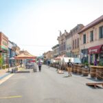 People walk up and down the main street of an old mining town turned tourist destination