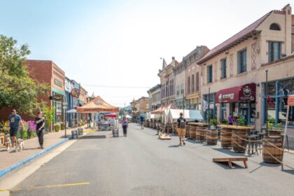 People walk up and down the main street of an old mining town turned tourist destination