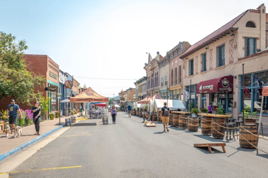 People walk up and down the main street of an old mining town turned tourist destination