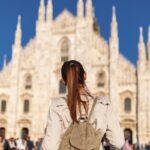 Tourist woman near Duomo di Milano cathedral church. Milan, Italy