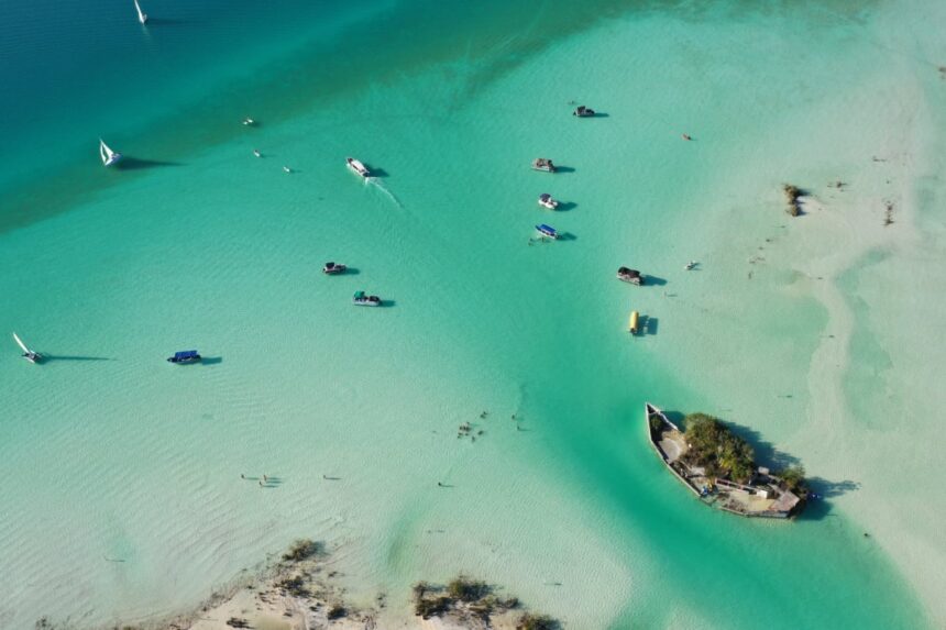 Aerial view of boats in turquoise water of Bacalar, Mexico