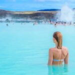 A woman enjoys spa in hot spring Blue Lagoon in Iceland