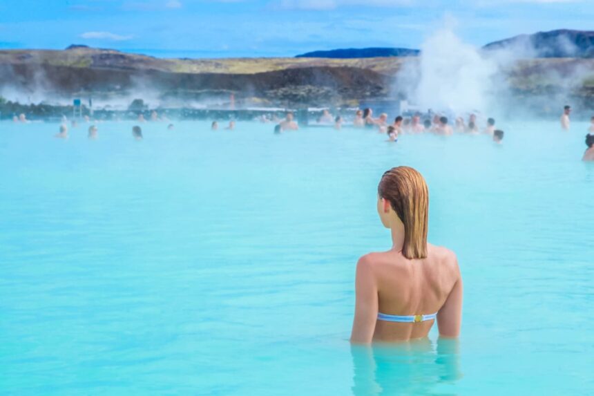 A woman enjoys spa in hot spring Blue Lagoon in Iceland
