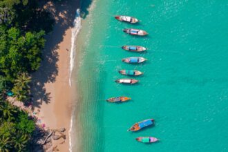 Banner Travel photo Thailand. Aerial view turquoise water, tropical beach Phuket with longtail boat.