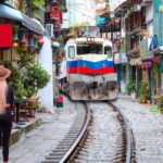 Female tourist visiting famous Train Street in Hanoi