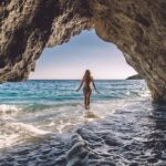 Female beachgoer in sea cave in Albania
