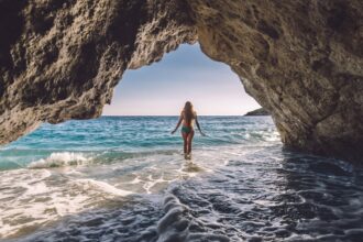Female beachgoer in sea cave in Albania