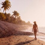 Woman walking along the beach in El Tunco, El Salvador
