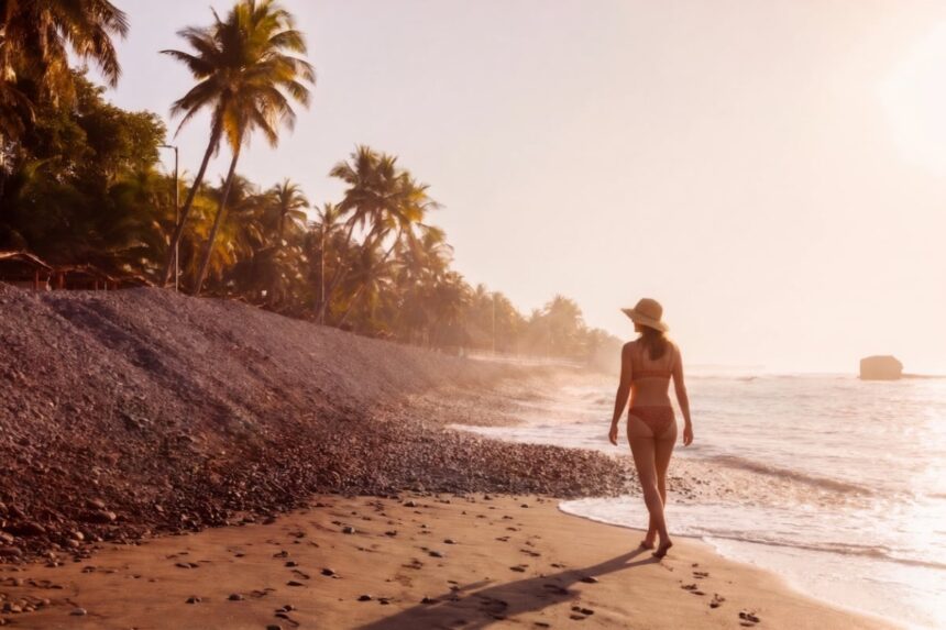 Woman walking along the beach in El Tunco, El Salvador